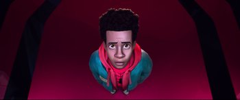 Movie still from “Spider-Man: Into the Spider-Verse” (2018), directed by Peter Ramsey – A cartoon of a man with a red scarf on; Close Up shot, Overhead angle