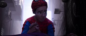 Movie still from “Spider-Man: Into the Spider-Verse” (2018), directed by Peter Ramsey – A young boy wearing a spider - man shirt and hat; Close Up shot, High angle