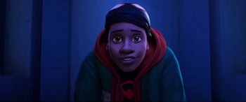 Movie still from “Spider-Man: Into the Spider-Verse” (2018), directed by Peter Ramsey – A young man in a blue hoodie and a red and black hat; Close Up shot, Low angle