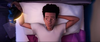 Movie still from “Spider-Man: Into the Spider-Verse” (2018), directed by Peter Ramsey – An animation of a boy laying in bed with his hands behind his head; Medium shot, High angle