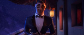 Movie still from “Spies in Disguise” (2019), directed by Troy Quane – A man in a suit and bow tie standing in front of a lantern; Medium shot, Low angle