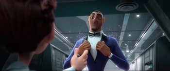 Movie still from “Spies in Disguise” (2019), directed by Troy Quane – A man in a suit and bow tie is looking at himself in the mirror; Medium shot, Over the shoulder angle