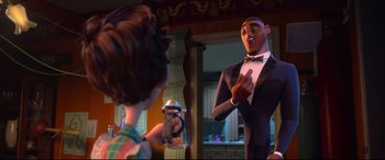Movie still from “Spies in Disguise” (2019), directed by Troy Quane – A man in a suit and bow tie talking to a woman in front of a mirror; Medium shot, Over the shoulder angle