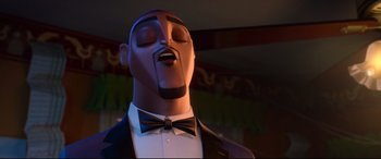 Movie still from “Spies in Disguise” (2019), directed by Troy Quane – A man's face in a suit and bow tie; Close Up shot, Low angle