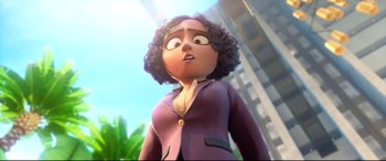 Movie still from “Spies in Disguise” (2019), directed by Troy Quane – An animated woman in a purple suit looks at the camera; Medium shot, Low angle