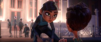 Movie still from “Spies in Disguise” (2019), directed by Troy Quane – A woman is looking at another woman in front of a building; Medium shot, Over the shoulder angle