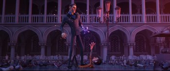 Movie still from “Spies in Disguise” (2019), directed by Troy Quane – A man is standing over another man on a stage; Wide shot, Low angle