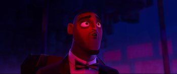 Movie still from “Spies in Disguise” (2019), directed by Troy Quane – A person wearing a suit and bow tie; Close Up shot, Low angle