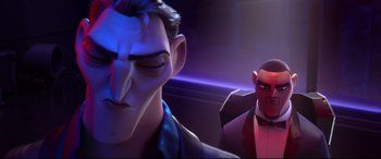 Movie still from “Spies in Disguise” (2019), directed by Troy Quane – Two animated characters are standing in front of a purple light; Close Up shot, Over the shoulder angle