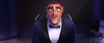 Movie still from “Spies in Disguise” (2019), directed by Troy Quane – An image of an animated character in a suit and bow tie; Close Up shot, Low angle