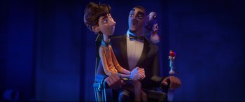 Movie still from “Spies in Disguise” (2019), directed by Troy Quane – A man and a woman sitting in a chair; Medium shot, Over the shoulder angle