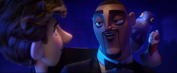 Movie still from “Spies in Disguise” (2019), directed by Troy Quane – A man in a suit and tie next to another man in a suit and tie; Close Up shot, Over the shoulder angle