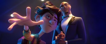 Movie still from “Spies in Disguise” (2019), directed by Troy Quane – A couple of people standing next to each other in a room; Close Up shot, Over the shoulder angle