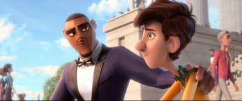 Movie still from “Spies in Disguise” (2019), directed by Troy Quane – Two animated characters in front of a white building; Close Up shot, Over the shoulder angle