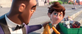 Movie still from “Spies in Disguise” (2019), directed by Troy Quane – A man and a woman holding each other's shoulders in front of a building; Close Up shot, Over the shoulder angle