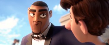 Movie still from “Spies in Disguise” (2019), directed by Troy Quane – A man in a suit and bow tie talking to another man in a suit and bow tie; Close Up shot, Over the shoulder angle