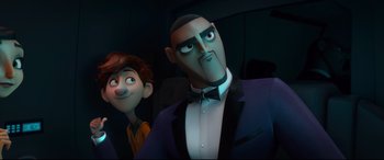 Movie still from “Spies in Disguise” (2019), directed by Troy Quane – A man in a suit and a boy in a yellow shirt; Medium shot, Over the shoulder angle
