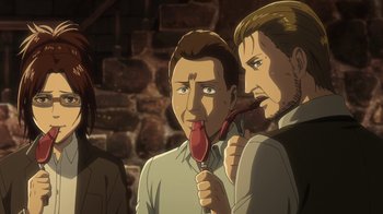 Movie still from “Attack on Titan” (2013), directed by Masashi Koizuka – A man holding an object up to his mouth while another man looks on; Close Up shot, High angle