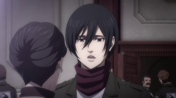 Movie still from “Attack on Titan” (2013), directed by Masashi Koizuka – A person with short black hair wearing a scarf; Close Up shot, Over the shoulder angle