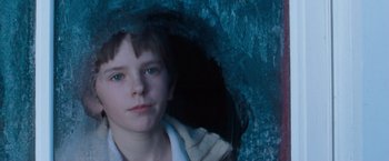 Movie still from “August Rush” (2007), directed by Kirsten Sheridan – A young boy is standing under an umbrella; Close Up shot, Low angle