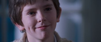 Movie still from “August Rush” (2007), directed by Kirsten Sheridan – A young boy's face; Close Up shot, Over the shoulder angle