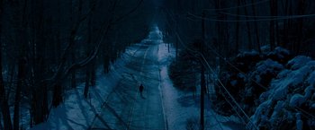 Movie still from “August Rush” (2007), directed by Kirsten Sheridan – A person walking down a snow covered road; Extreme Wide shot, High angle