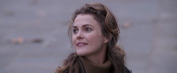 Movie still from “August Rush” (2007), directed by Kirsten Sheridan – A person wearing a sweater; Close Up shot, Over the shoulder angle