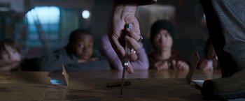 Movie still from “August Rush” (2007), directed by Kirsten Sheridan – A person holding a pair of scissors in front of two children; Extreme Close Up shot, High angle