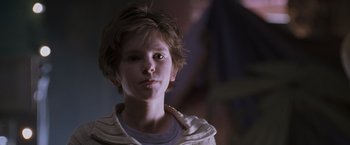 Movie still from “August Rush” (2007), directed by Kirsten Sheridan – A young boy is looking into the camera; Close Up shot, Over the shoulder angle