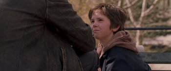 Movie still from “August Rush” (2007), directed by Kirsten Sheridan – A young boy standing next to an older man; Close Up shot, Over the shoulder angle