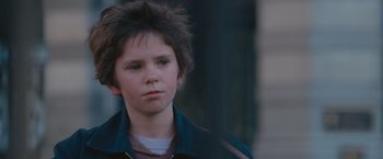 Movie still from “August Rush” (2007), directed by Kirsten Sheridan – A young boy is looking into the distance; Close Up shot, Over the shoulder angle