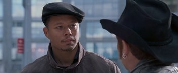 Movie still from “August Rush” (2007), directed by Kirsten Sheridan – A man wearing a black hat looking at another man; Close Up shot, Over the shoulder angle