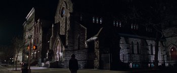 Movie still from “August Rush” (2007), directed by Kirsten Sheridan – A person standing in front of a church at night; Extreme Wide shot, Low angle