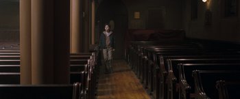 Movie still from “August Rush” (2007), directed by Kirsten Sheridan – A person standing in a room with many pews; Wide shot, High angle