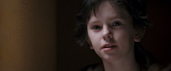 Movie still from “August Rush” (2007), directed by Kirsten Sheridan – A young person with blue eyes; Close Up shot, Low angle
