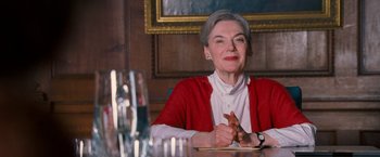 Movie still from “August Rush” (2007), directed by Kirsten Sheridan – An older woman sitting at a dinner table; Medium shot, Low angle