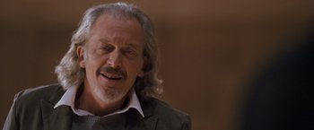Movie still from “August Rush” (2007), directed by Kirsten Sheridan – An older man with long grey hair and a beard; Close Up shot, Low angle