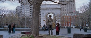 Movie still from “August Rush” (2007), directed by Kirsten Sheridan – A man standing next to a tree holding a guitar; Wide shot, Over the shoulder angle
