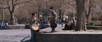 Movie still from “August Rush” (2007), directed by Kirsten Sheridan – Two young men playing guitars in a park; Wide shot, Over the shoulder angle