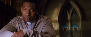 Movie still from “August Rush” (2007), directed by Kirsten Sheridan – A person sitting in a room; Close Up shot, Low angle