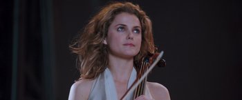 Movie still from “August Rush” (2007), directed by Kirsten Sheridan – A woman holding a violin in her hands; Close Up shot, Low angle