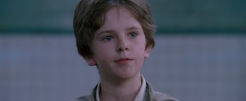 Movie still from “August Rush” (2007), directed by Kirsten Sheridan – A young boy is looking into the distance; Close Up shot, Over the shoulder angle