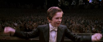Movie still from “August Rush” (2007), directed by Kirsten Sheridan – A boy in a tuxedo standing in front of an audience; Close Up shot, High angle