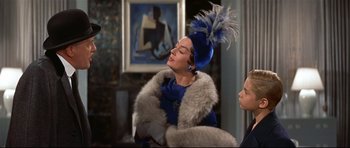 Movie still from “Auntie Mame” (1958), directed by Morton DaCosta – A woman in a blue dress and a blue hat; Medium shot, Low angle
