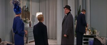 Movie still from “Auntie Mame” (1958), directed by Morton DaCosta – A man and a boy in a room with curtains; Medium shot, Over the shoulder angle