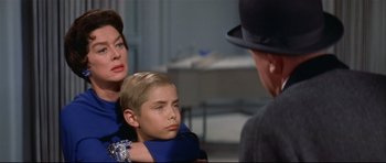 Movie still from “Auntie Mame” (1958), directed by Morton DaCosta – A woman and a boy are sitting next to each other; Close Up shot, Over the shoulder angle