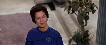 Movie still from “Auntie Mame” (1958), directed by Morton DaCosta – An older woman wearing a blue dress and a blue shawl; Close Up shot, Over the shoulder angle
