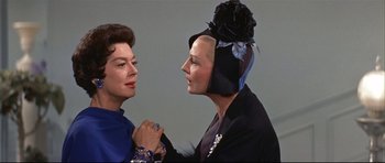 Movie still from “Auntie Mame” (1958), directed by Morton DaCosta – Two women are standing next to each other; Close Up shot, Over the shoulder angle
