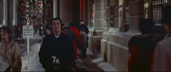 Movie still from “Auntie Mame” (1958), directed by Morton DaCosta – A man standing in the middle of a street; Medium shot, Low angle