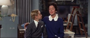 Movie still from “Auntie Mame” (1958), directed by Morton DaCosta – An older woman and a young boy sitting next to each other; Medium shot, Over the shoulder angle